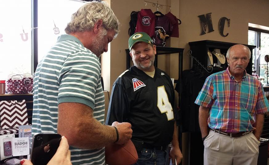 Brett Favre candid photo with Bus Cook nearby